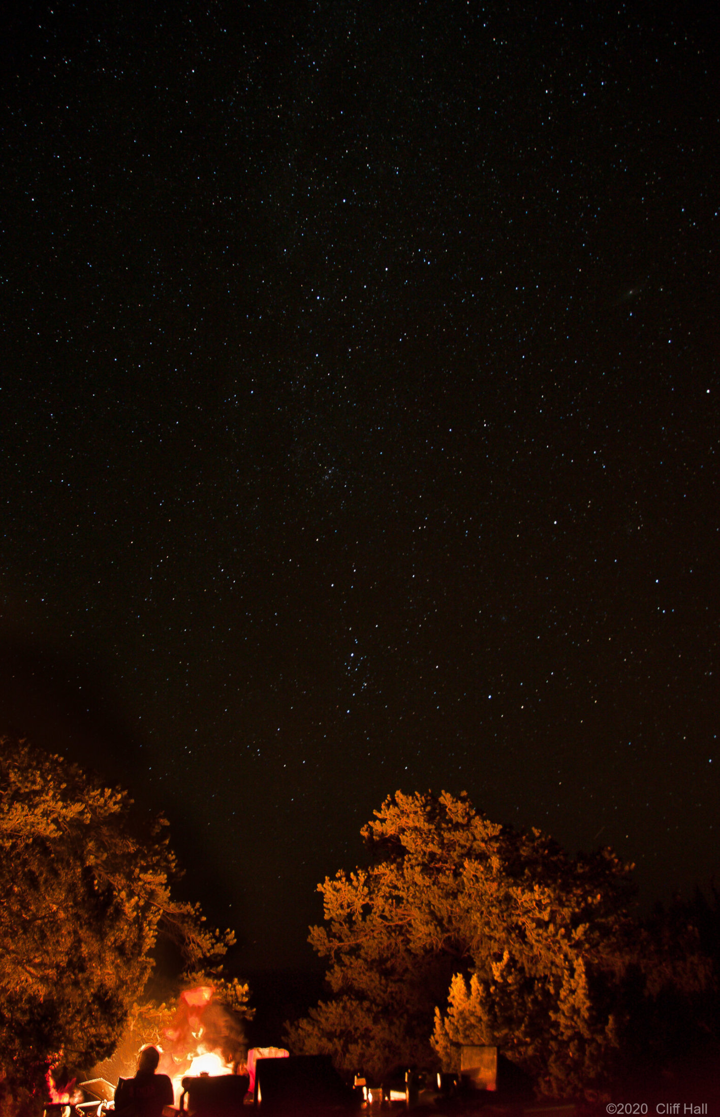 Camp fire under a starry night